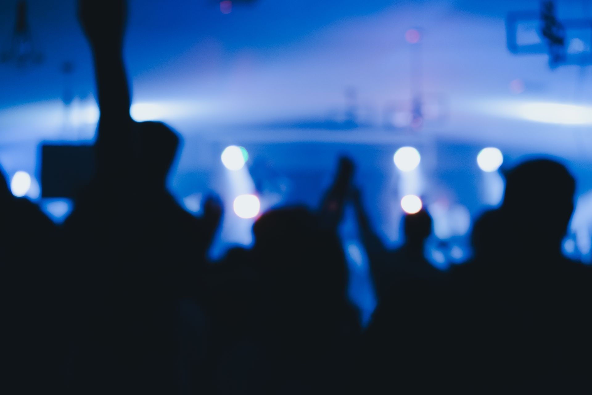 Blurred photo of Christian worship God together in Church  and light bokeh effect.raised hand and praise the LORD. concert background.